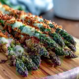 A close-up of Crispy Asparagus Asiago Spears highlighting their crunchy panko crust and tender green tips.  