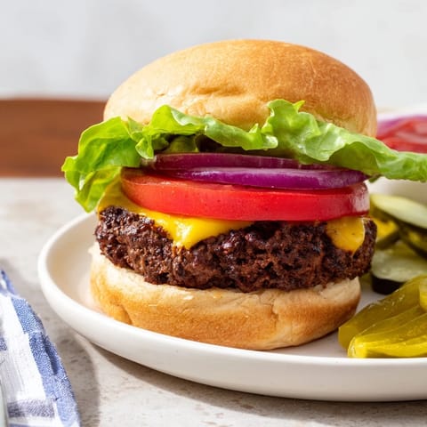 Freshly-made hamburgers, a classic American meal, loaded with toppings and ready to serve.