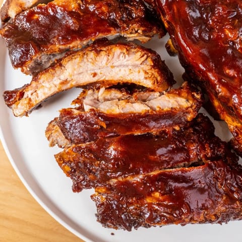 Juicy, glistening BBQ ribs, fall-off-the-bone tender with a rich, smoky barbecue glaze.