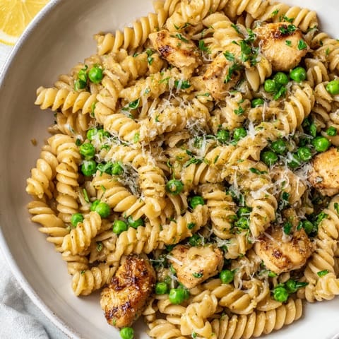 Garlic butter chicken and pea pasta tossed with fresh parsley and lemon zest for a bright, savory family dinner.  