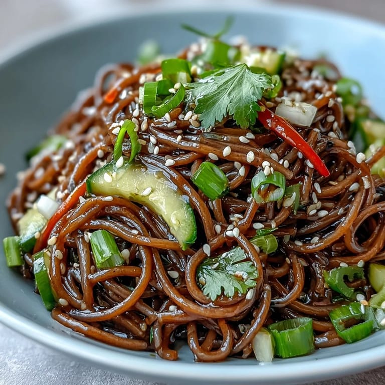 Chilled soba noodles, colorful vegetables, and sesame ginger dressing in a refreshing summer salad.