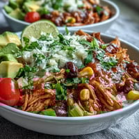 Vibrant salsa chicken bowls with tender shredded chicken, black beans, corn, and fresh toppings served over rice.