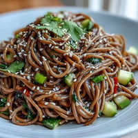 Cold Soba Noodle Salad with Sesame Ginger Dressing, vibrant colors, crisp veggies, tangy dressing.